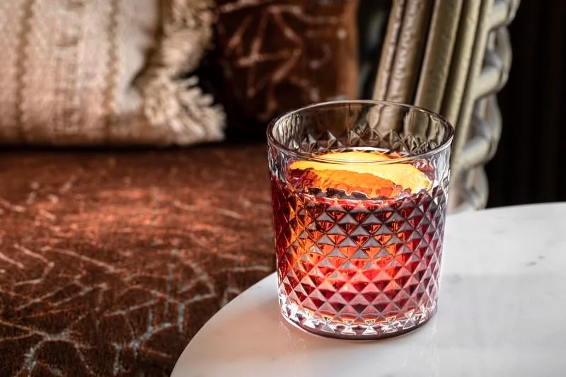 Classic cocktail served in a crystal glass with an orange twist