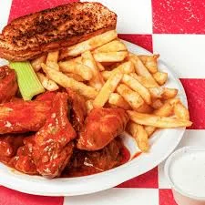 Buffalo chicken wings with fries and celery