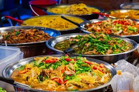 Assorted Asian dishes in large serving trays