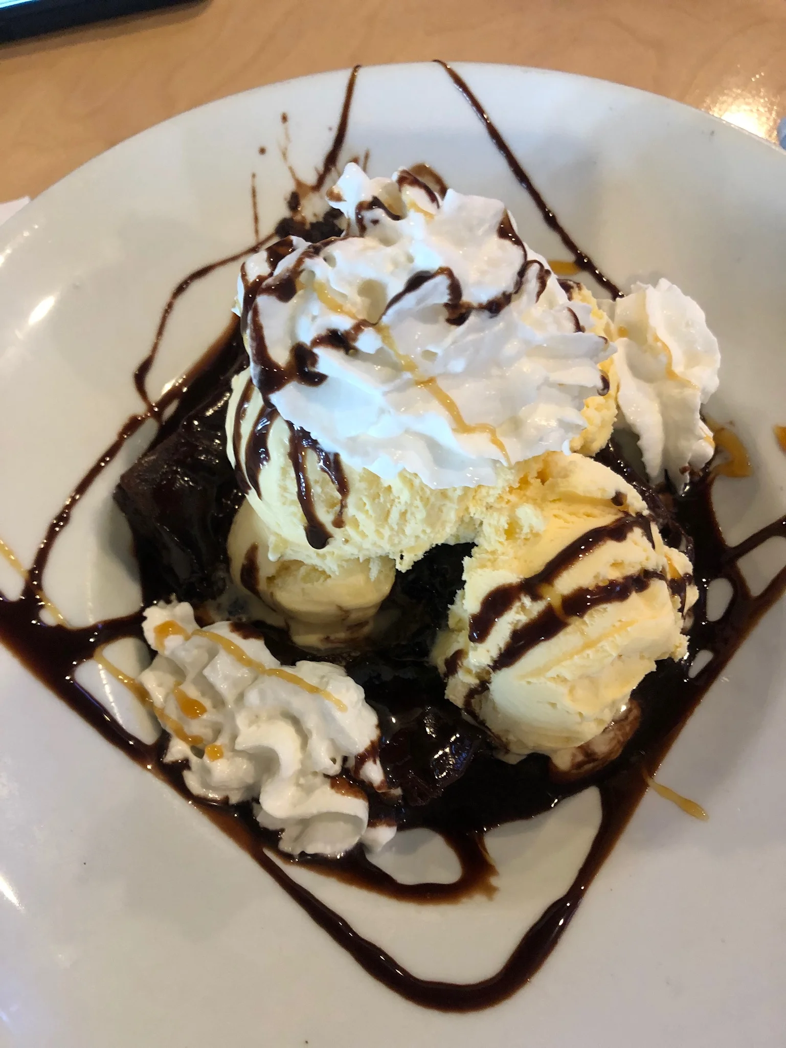 Decadent brownie sundae with vanilla ice cream and whipped cream