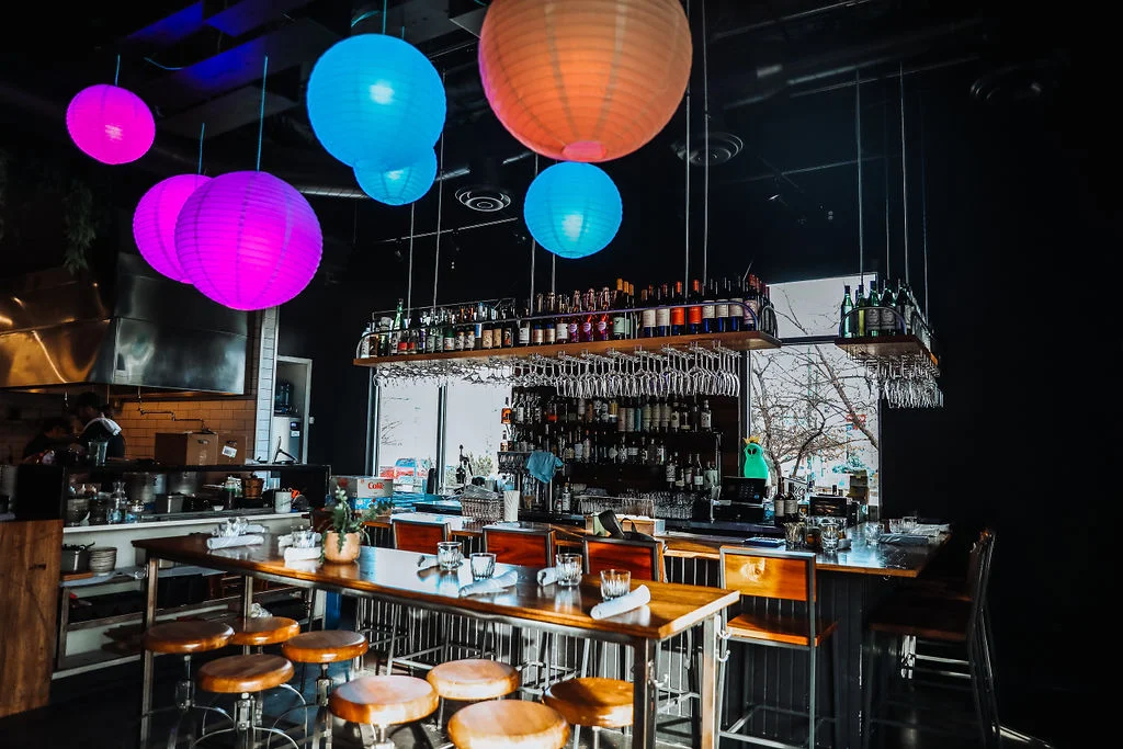 Stylish restaurant interior with colorful lanterns and bar