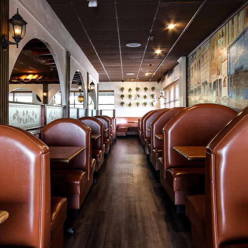 Cozy restaurant interior with leather booths and warm lighting