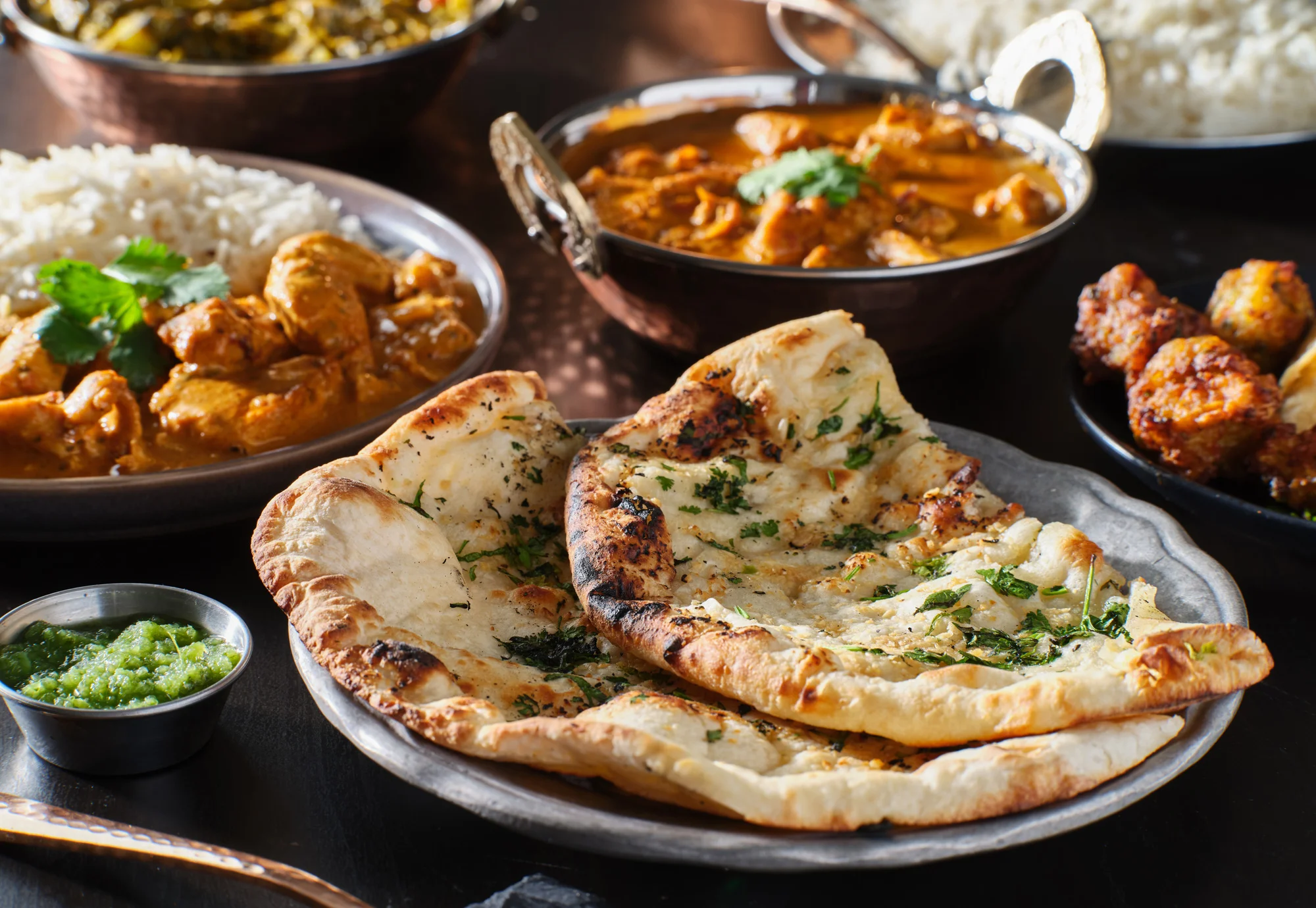 Indian naan bread served with curry and rice