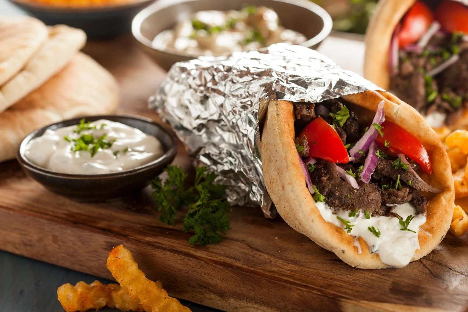 Mediterranean gyro wrapped in pita with fresh toppings