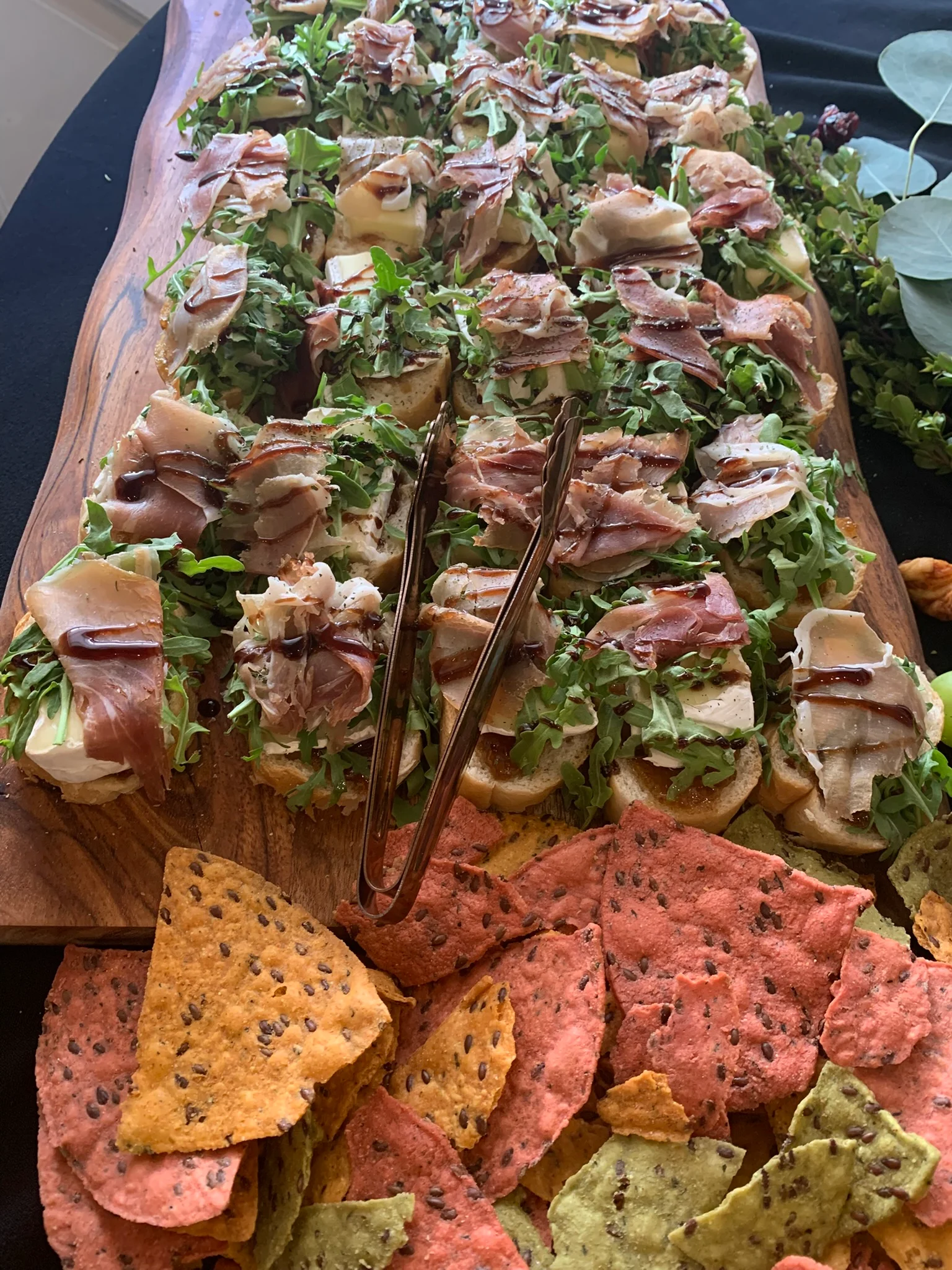 Italian antipasto platter with prosciutto and arugula on bread