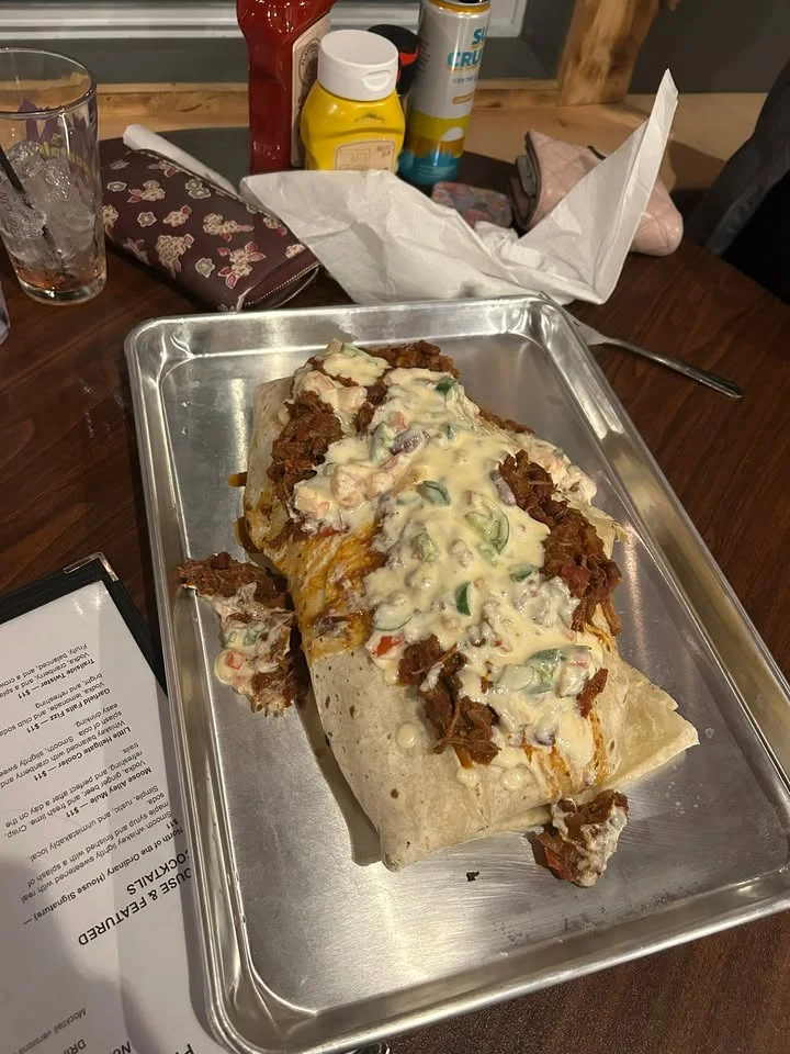 Loaded burrito smothered in cheese sauce