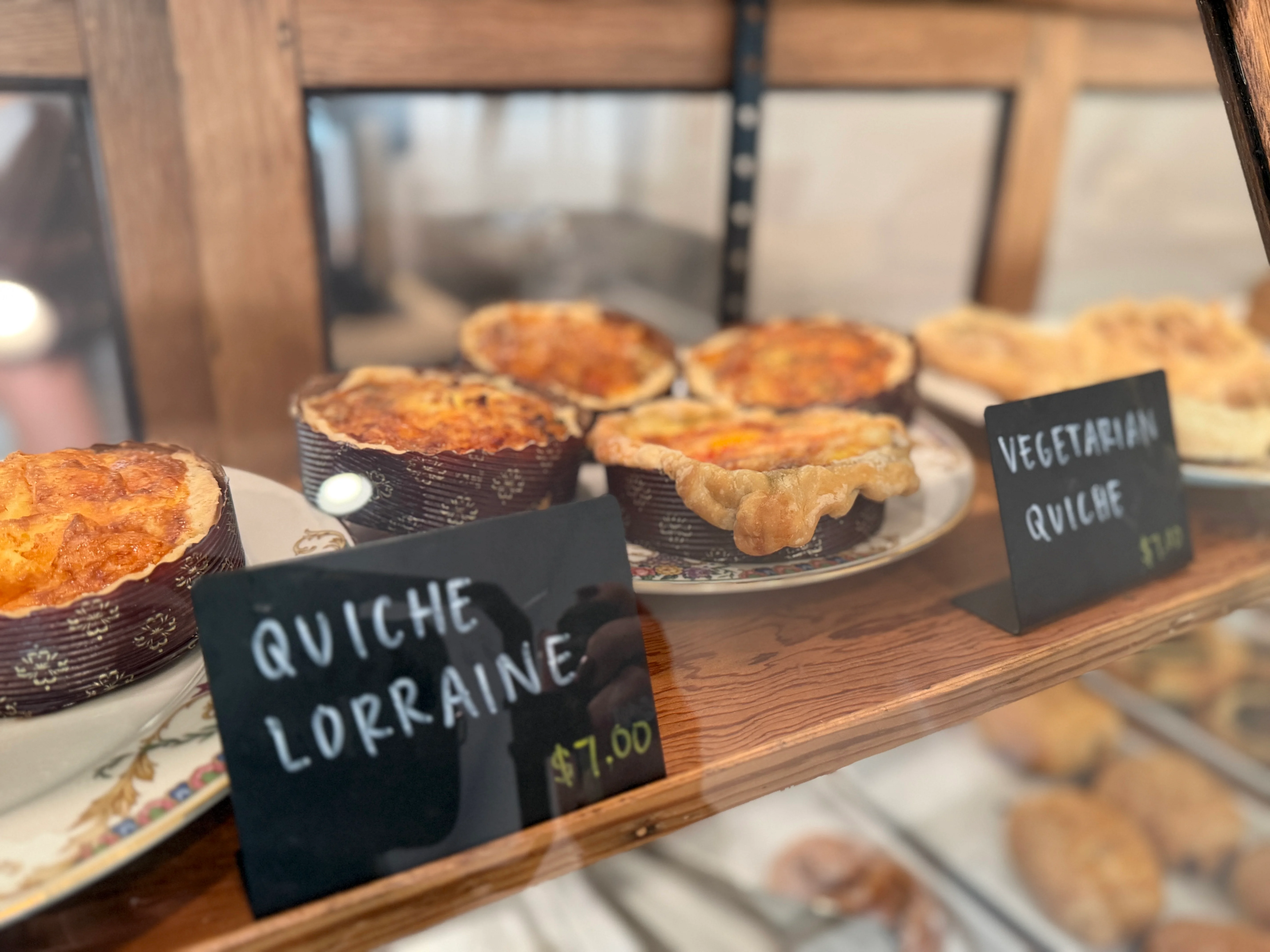 Freshly baked quiche Lorraine and vegetarian quiche in a bakery display