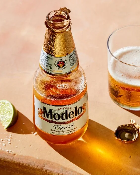 Chilled bottle of Modelo beer with lime and glass