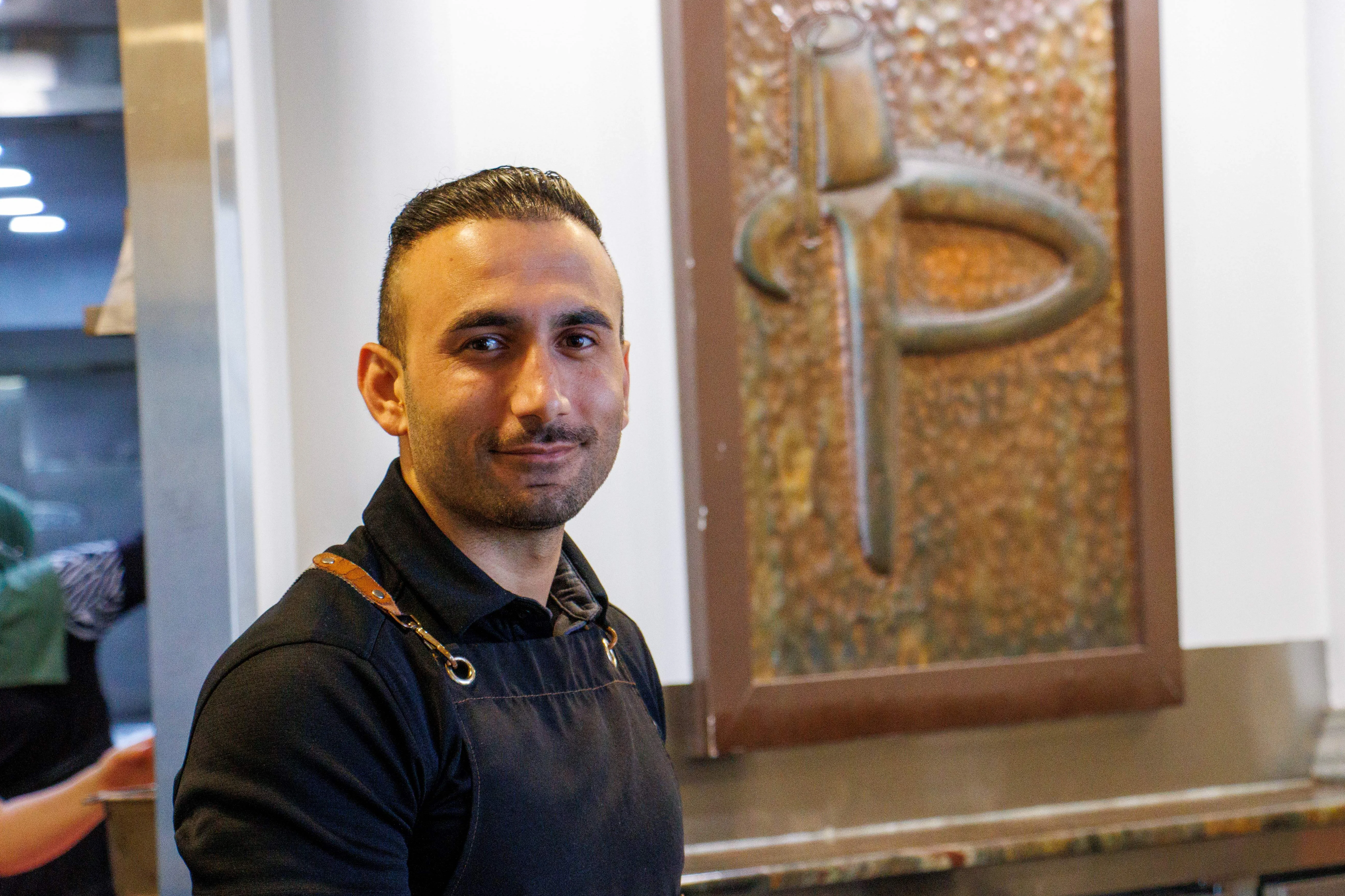 Restaurant staff member at a modern eatery counter
