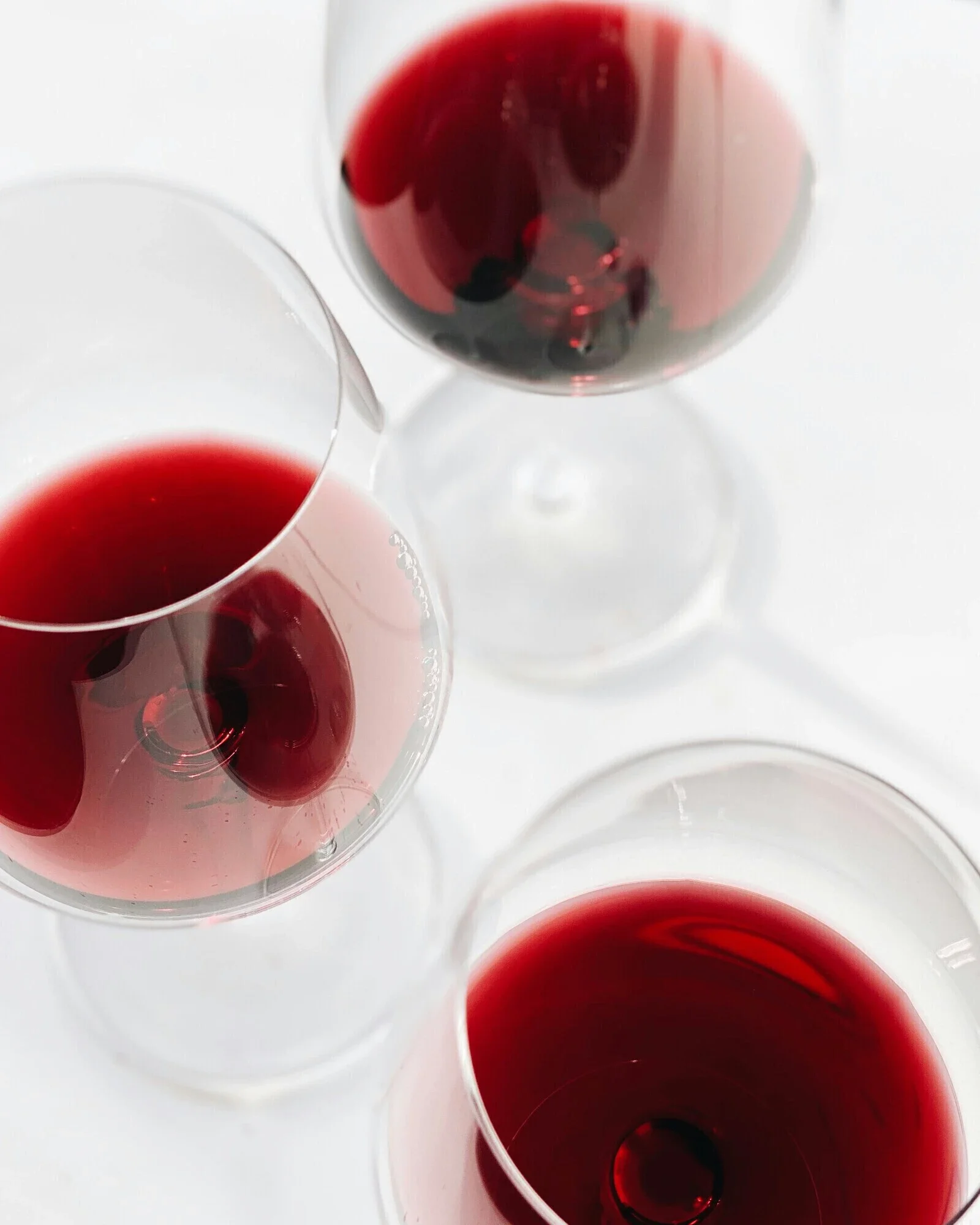 Elegant red wine glasses filled with rich wine