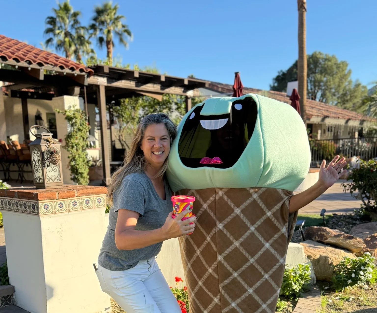 Fun ice cream mascot with a smiling woman in a garden setting