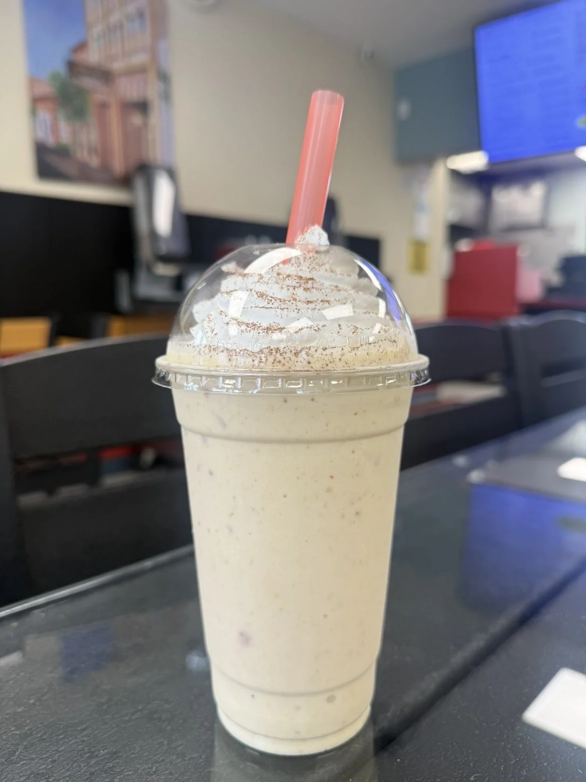 Colorful milkshake topped with whipped cream and sprinkles