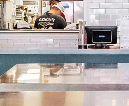 Modern restaurant interior with booths and menu board
