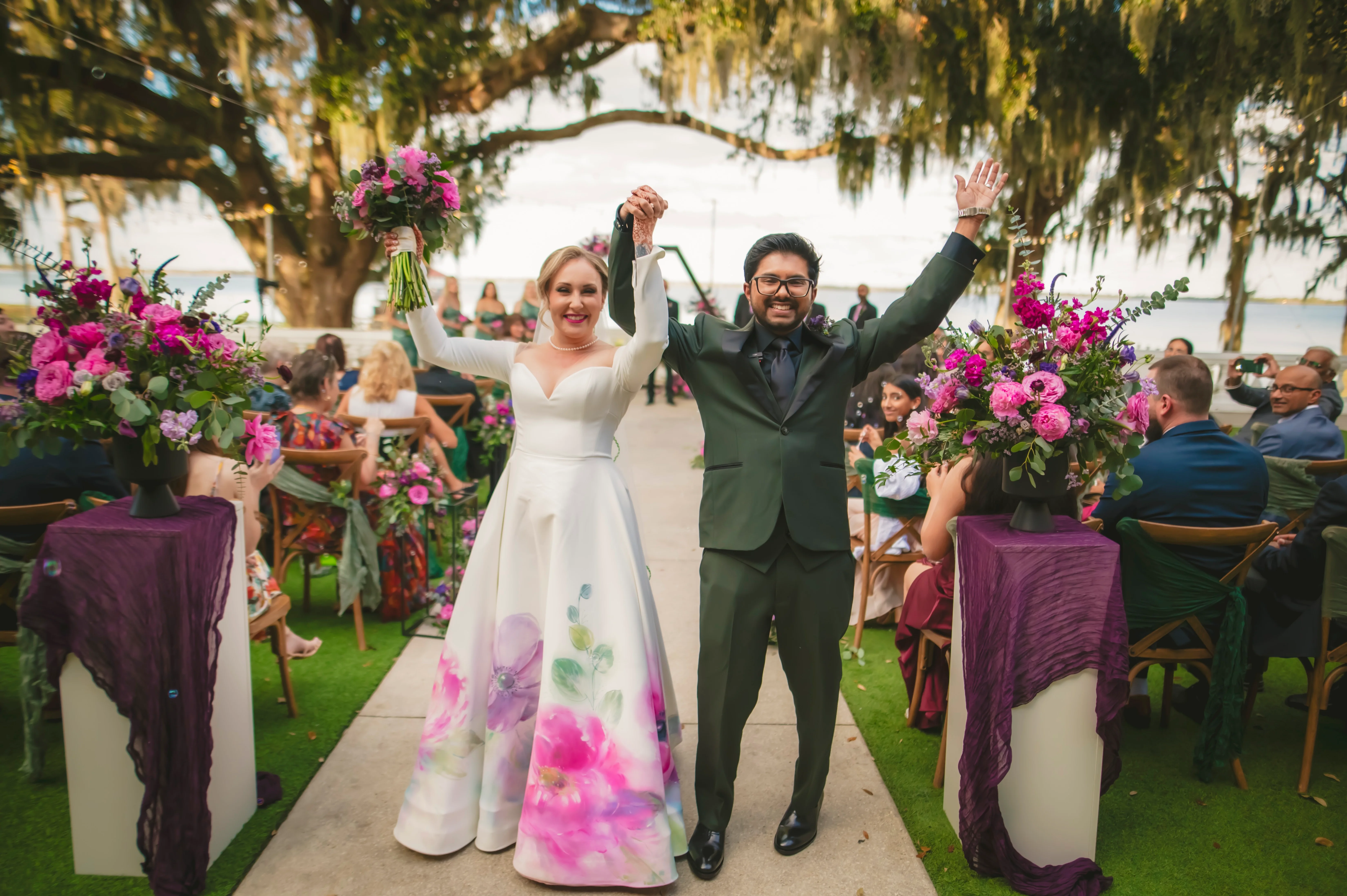 Happy couple celebrating their wedding outdoors with floral decorations