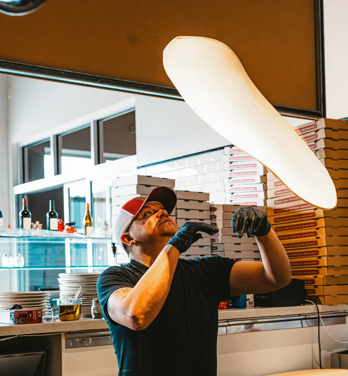 chef tossing pizza dough