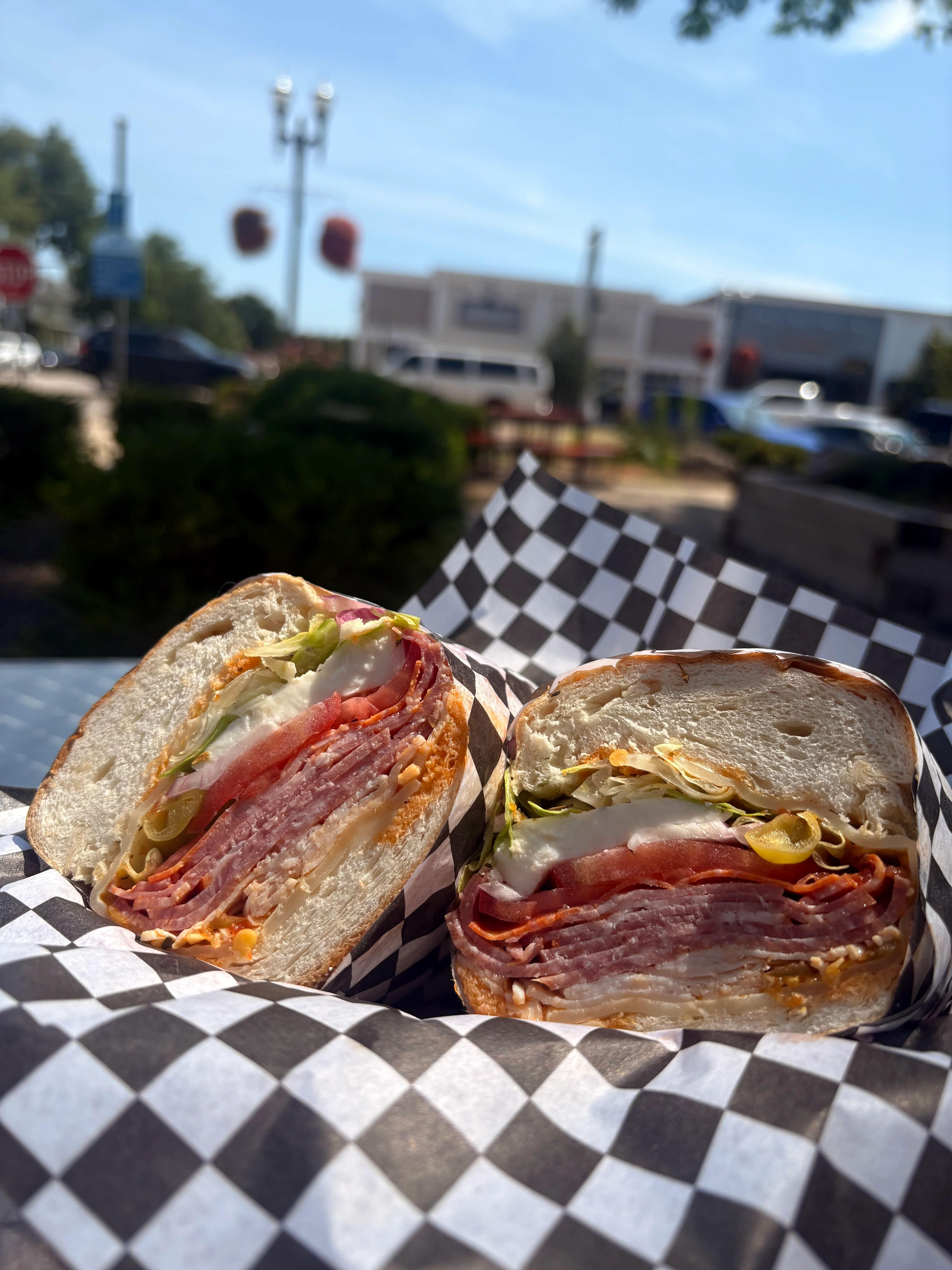 Italian sub sandwich with layers of meats and fresh vegetables