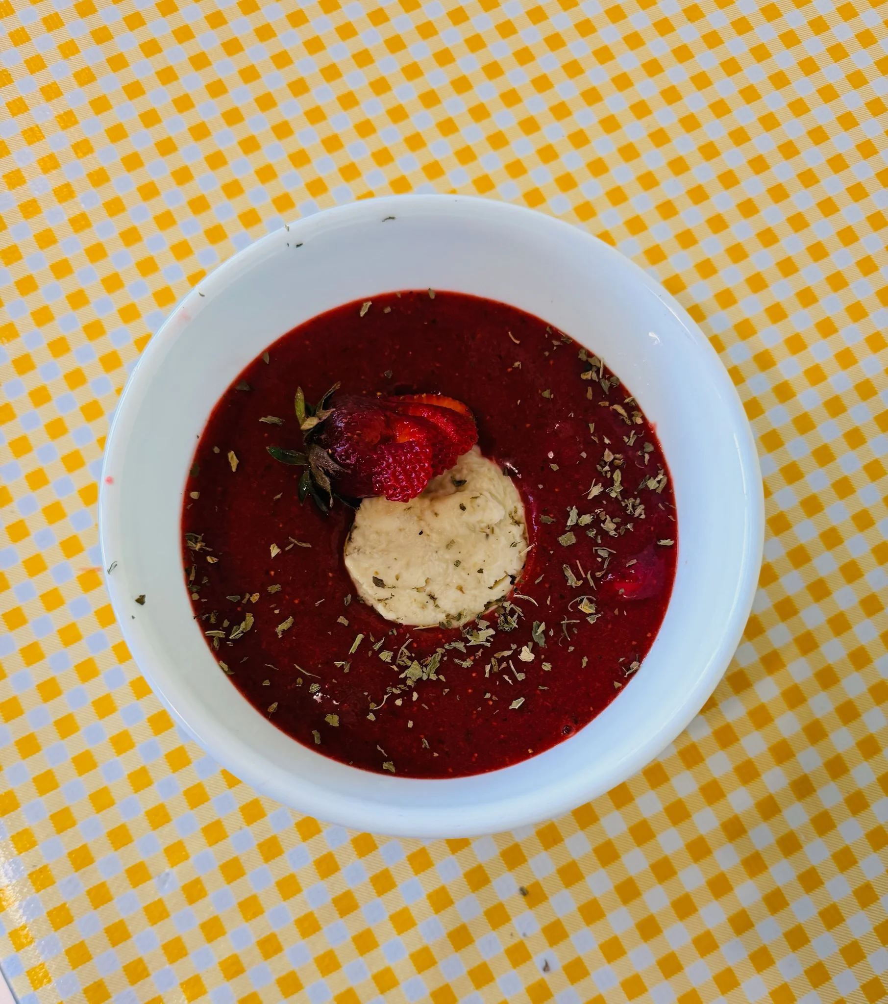 Chilled strawberry soup with herbs and cream