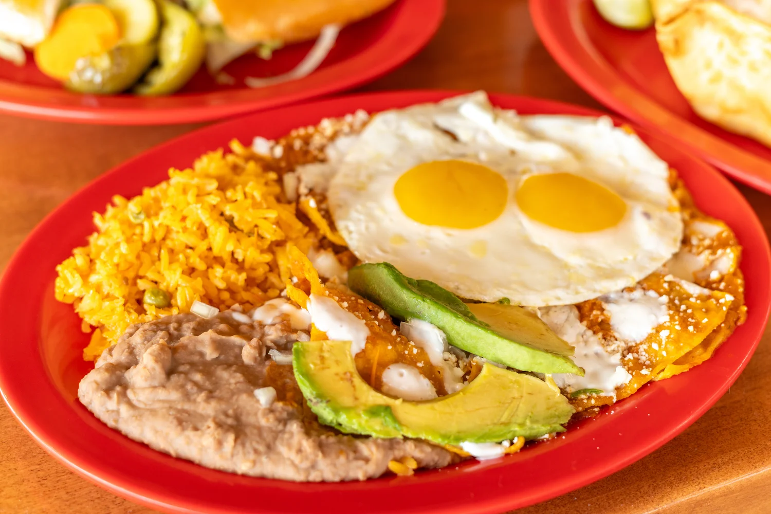 Traditional Mexican huevos rancheros with rice and beans