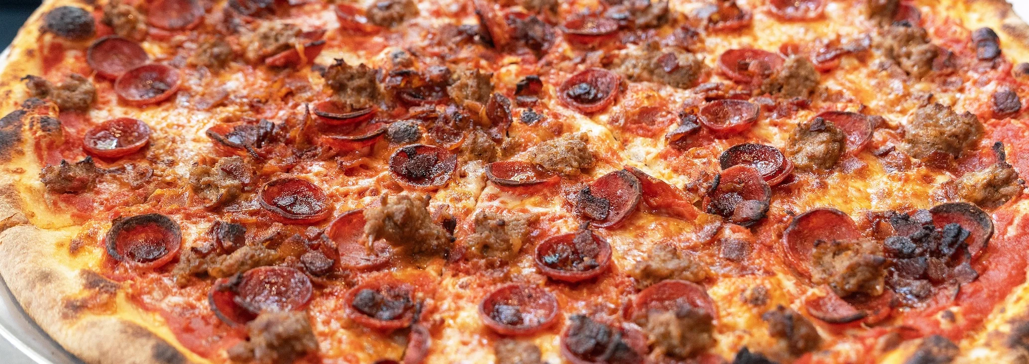 Pepperoni and sausage pizza from a pizzeria