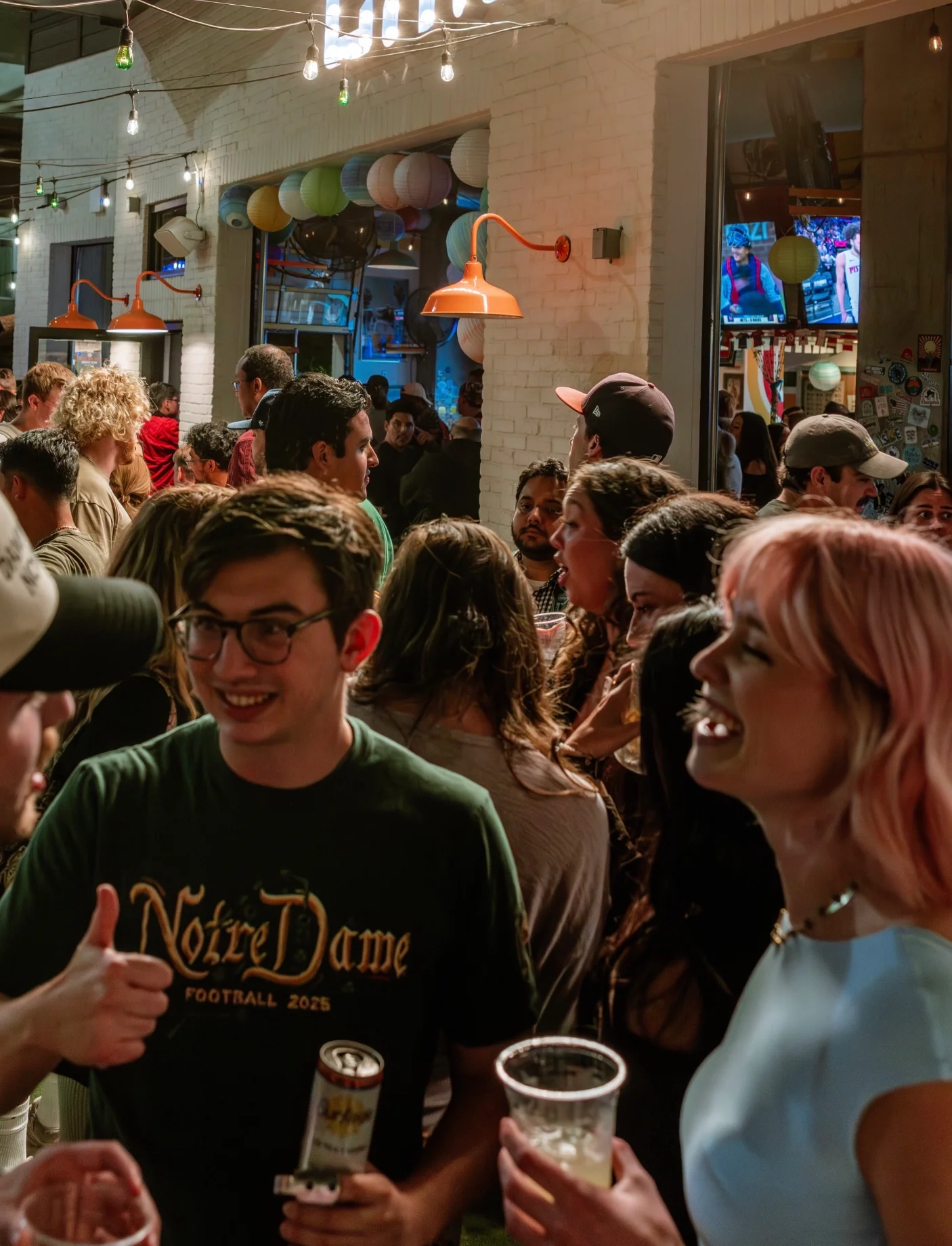 Young adults enjoying a drink and the ease of indoor outdoor experience at CHIRINGA O4Wennjo