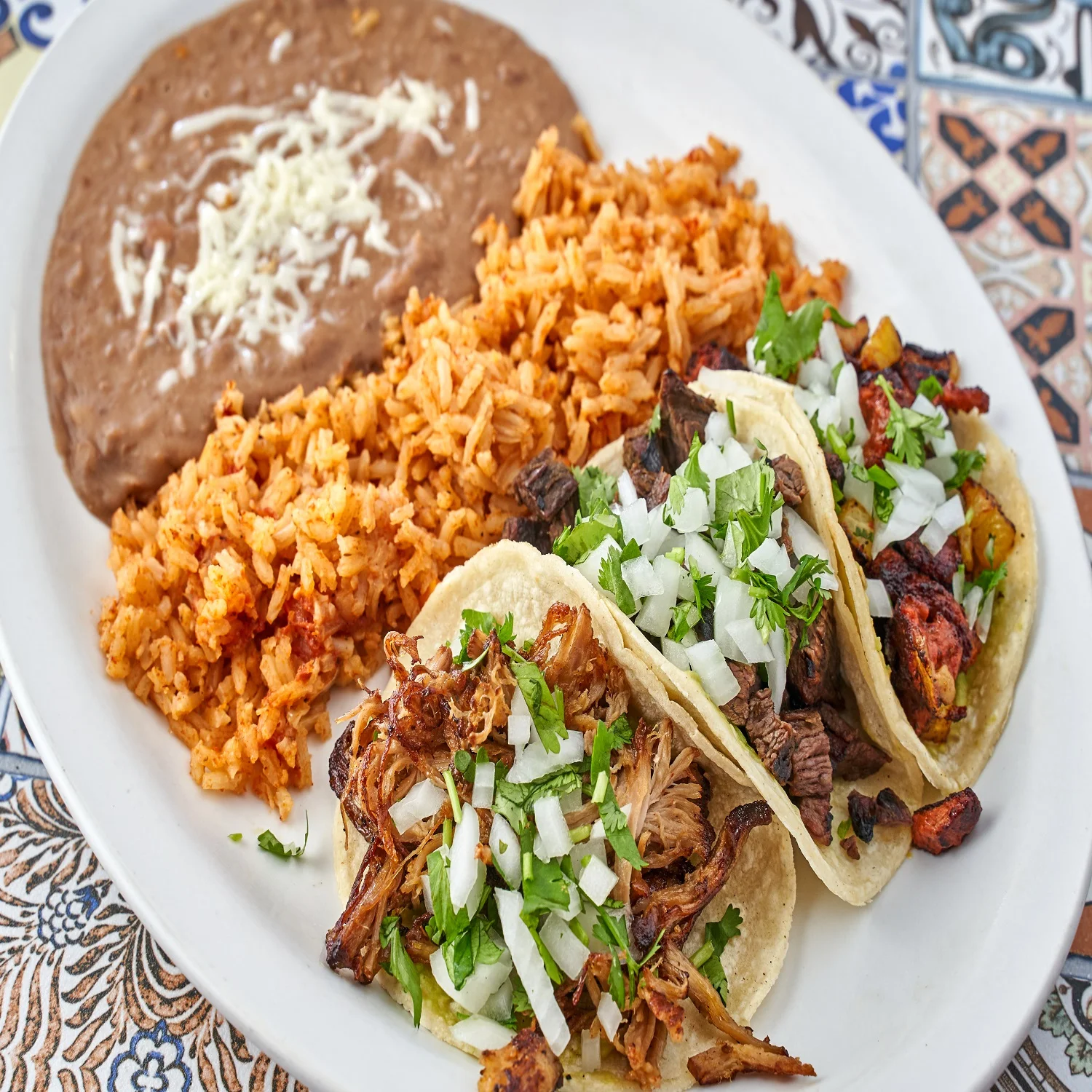 Authentic Mexican tacos with rice and refried beans