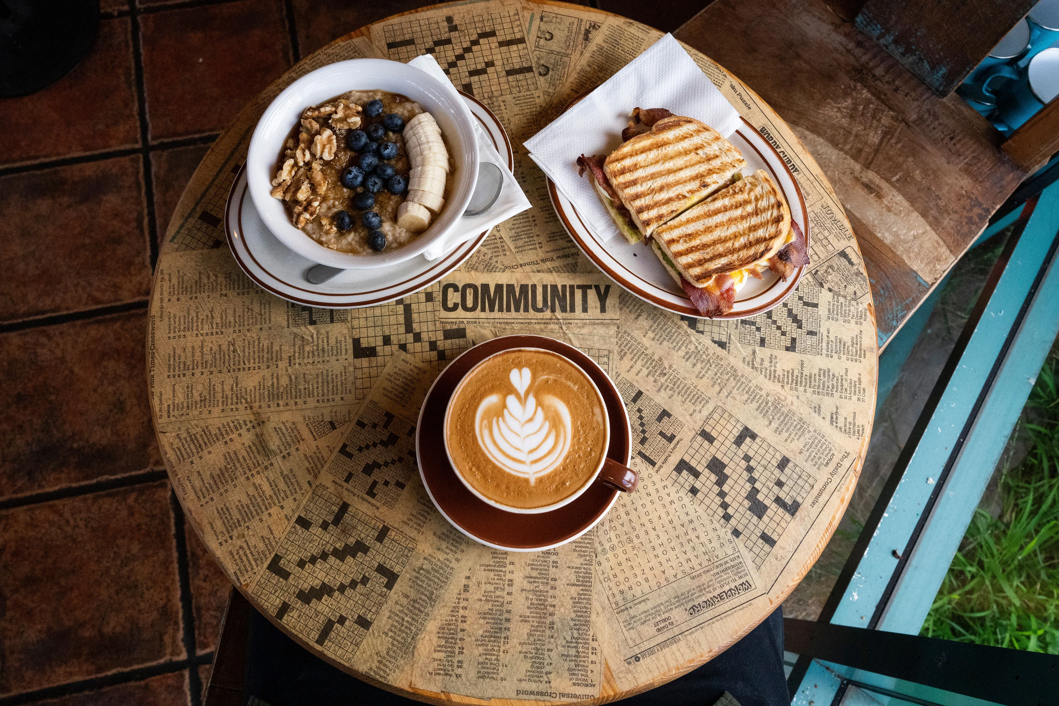 Breakfast bowl with oatmeal and coffee in a cozy café setting