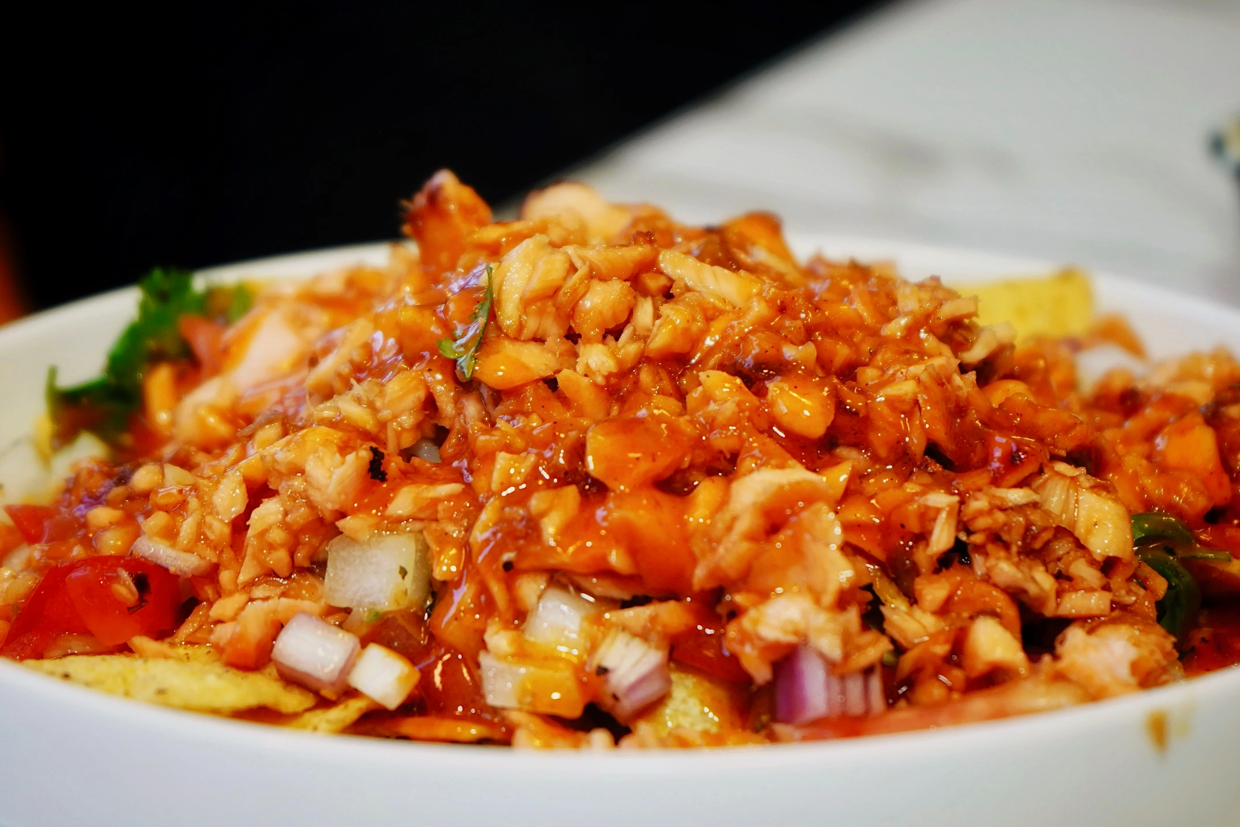 Delicious Indian chicken chaat topped with tangy sauce