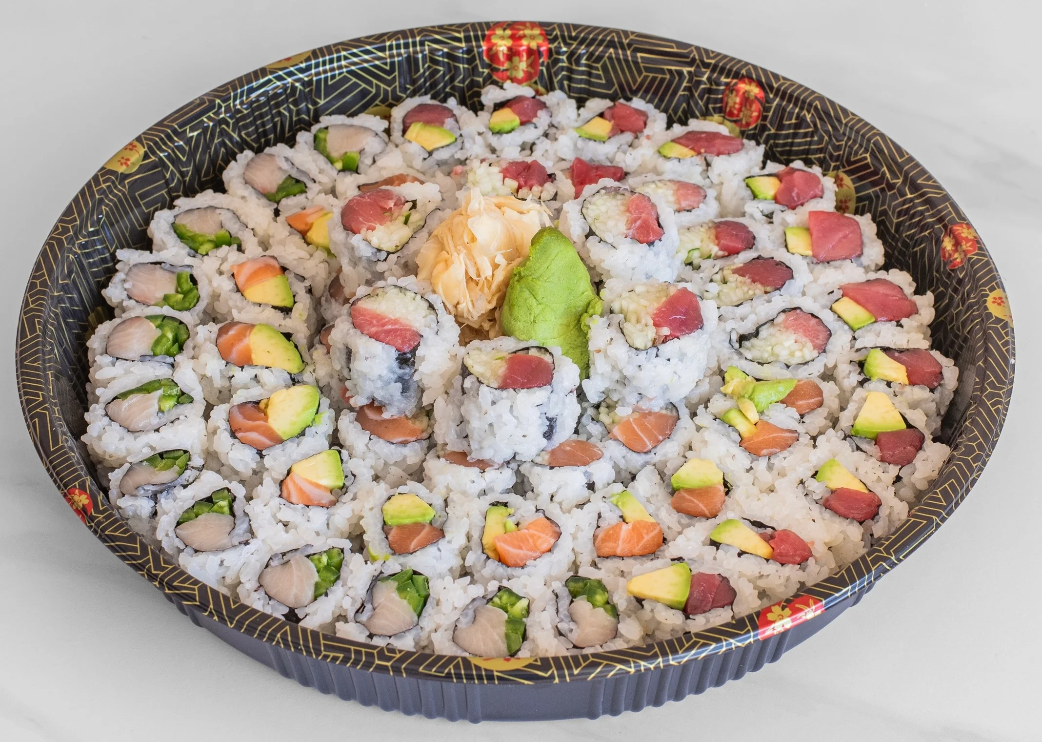 Assorted sushi platter featuring colorful rolls and garnishes