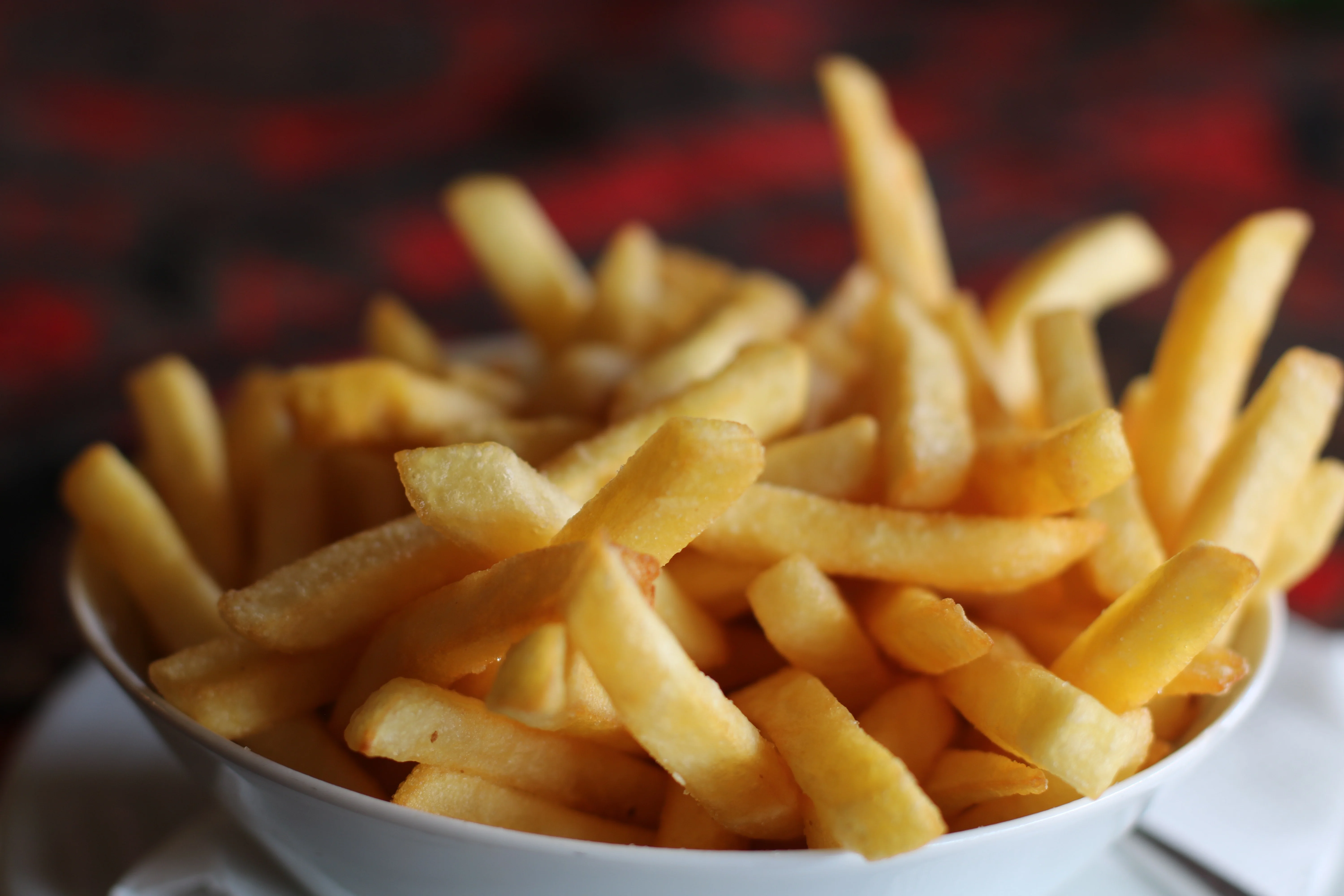Crispy French fries served in a white bowl