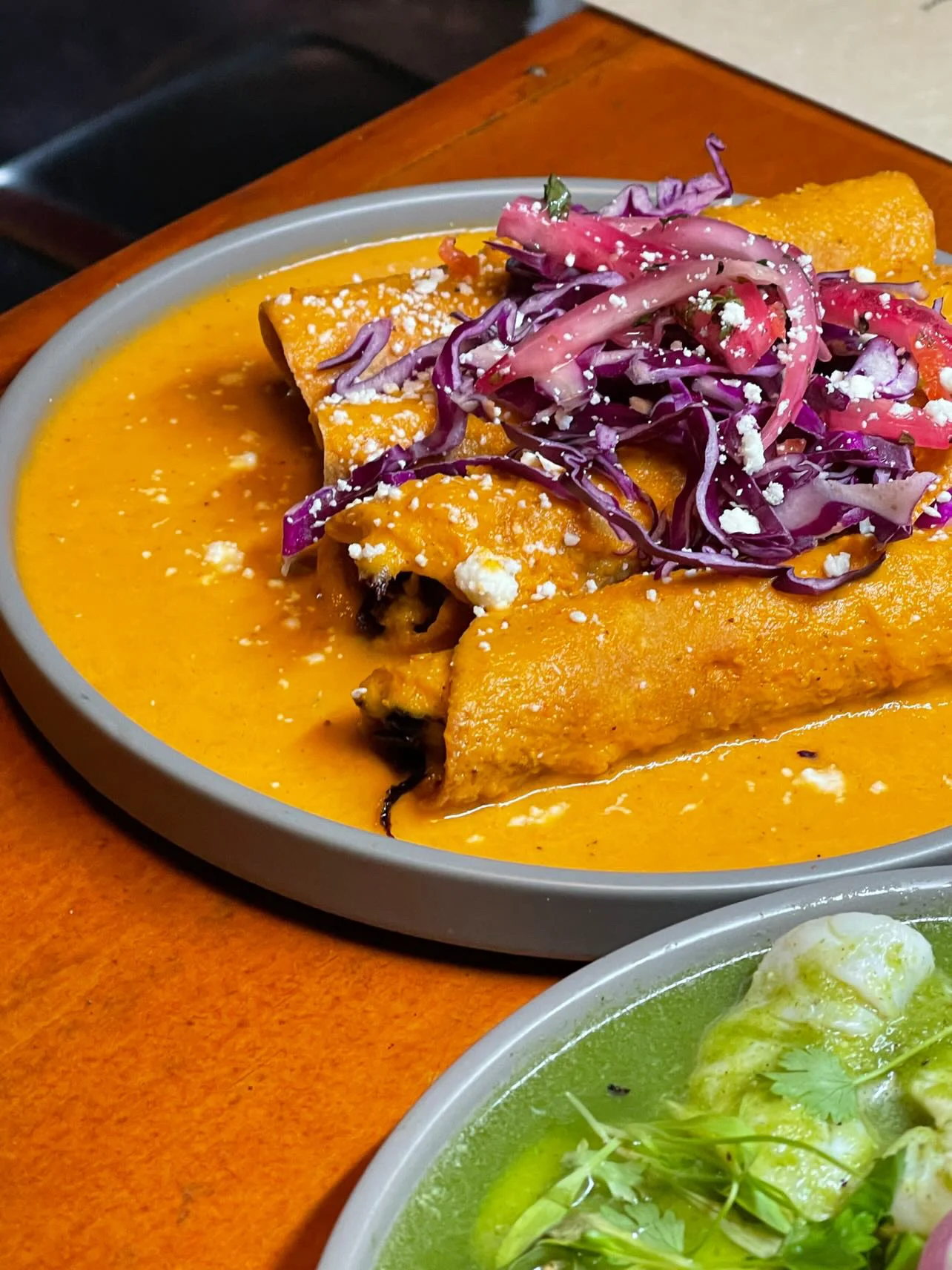 Delicious enchiladas in a rich sauce with fresh toppings