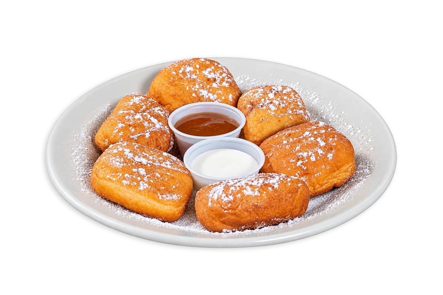 Delicious beignets dusted with powdered sugar and served with dipping sauces