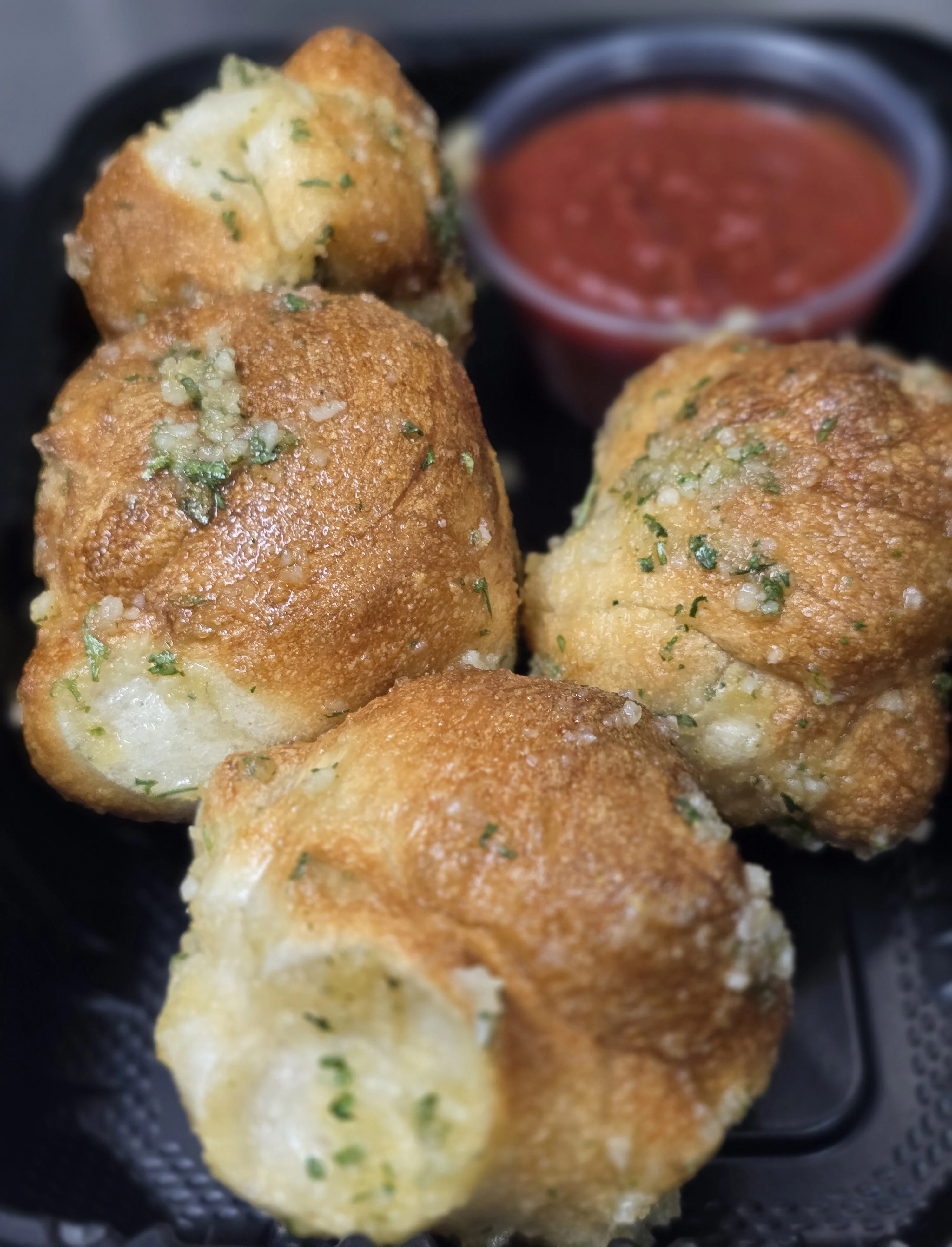 Garlic knots served with marinara sauce