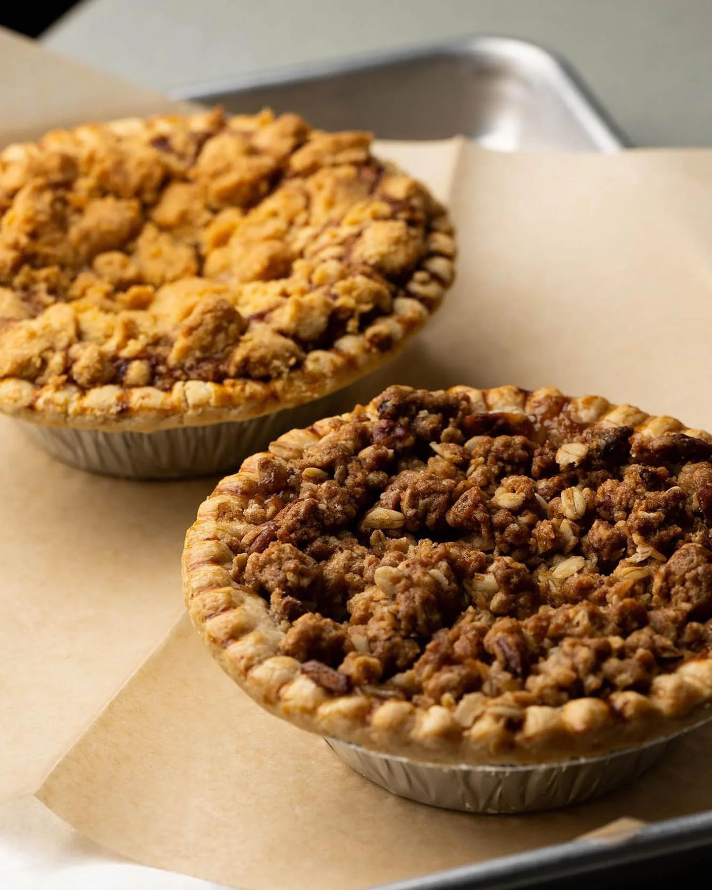 Delicious apple crumble pie and pecan pie on a serving tray