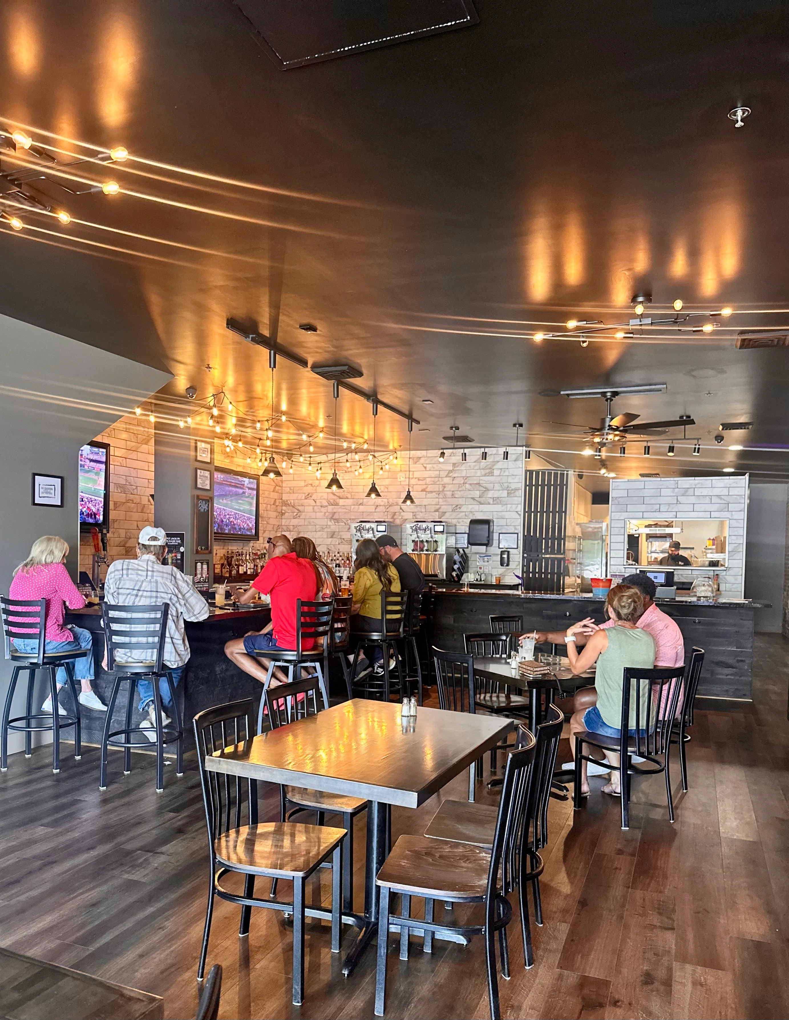 Cozy restaurant interior with warm lighting and patrons enjoying their meals
