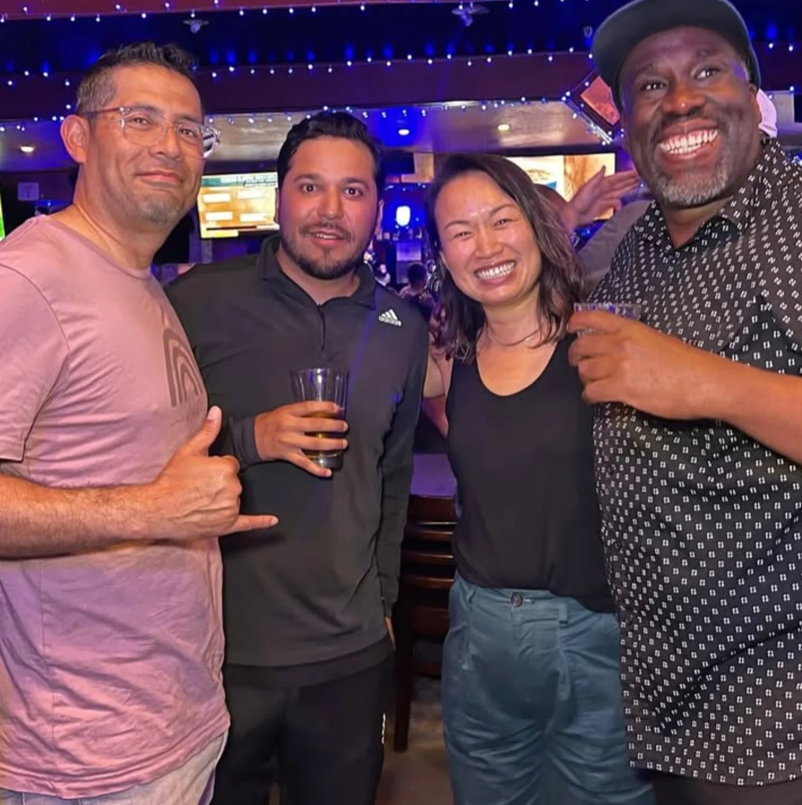 Group of friends enjoying drinks at a lively bar