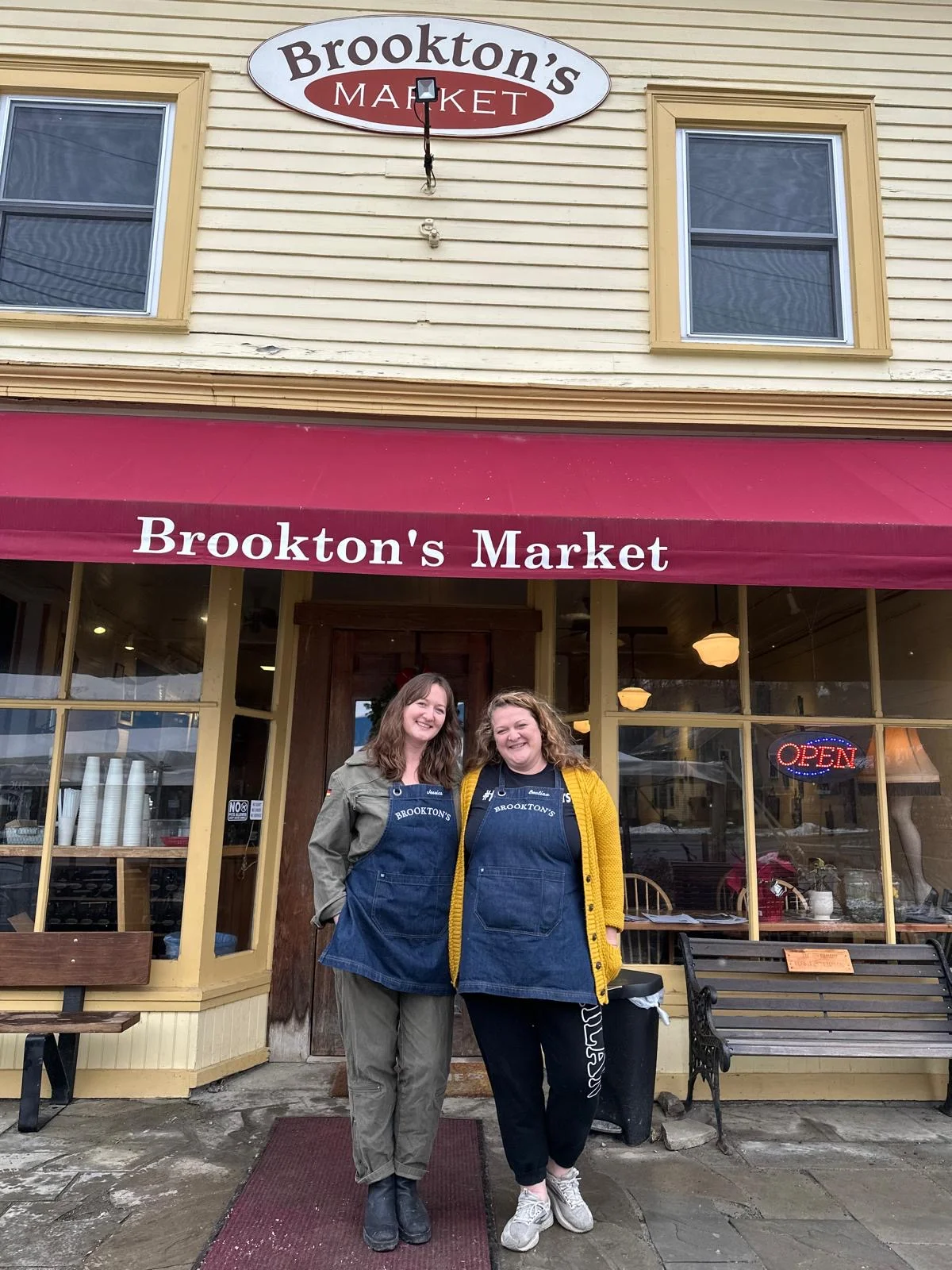 Two staff members outside Brookton's Market in aprons