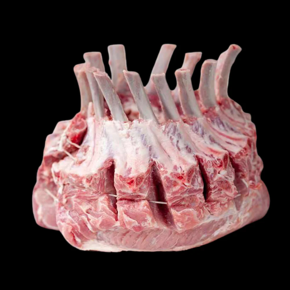 Raw rack of lamb with exposed ribs on a black background.