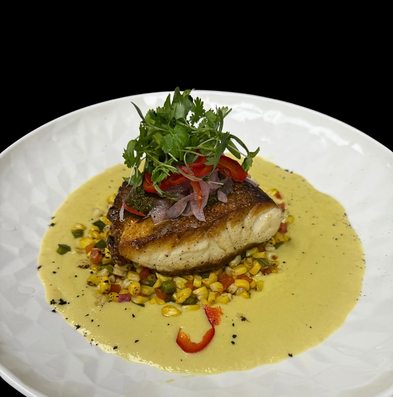 Pan-seared fish with corn salsa and creamy sauce