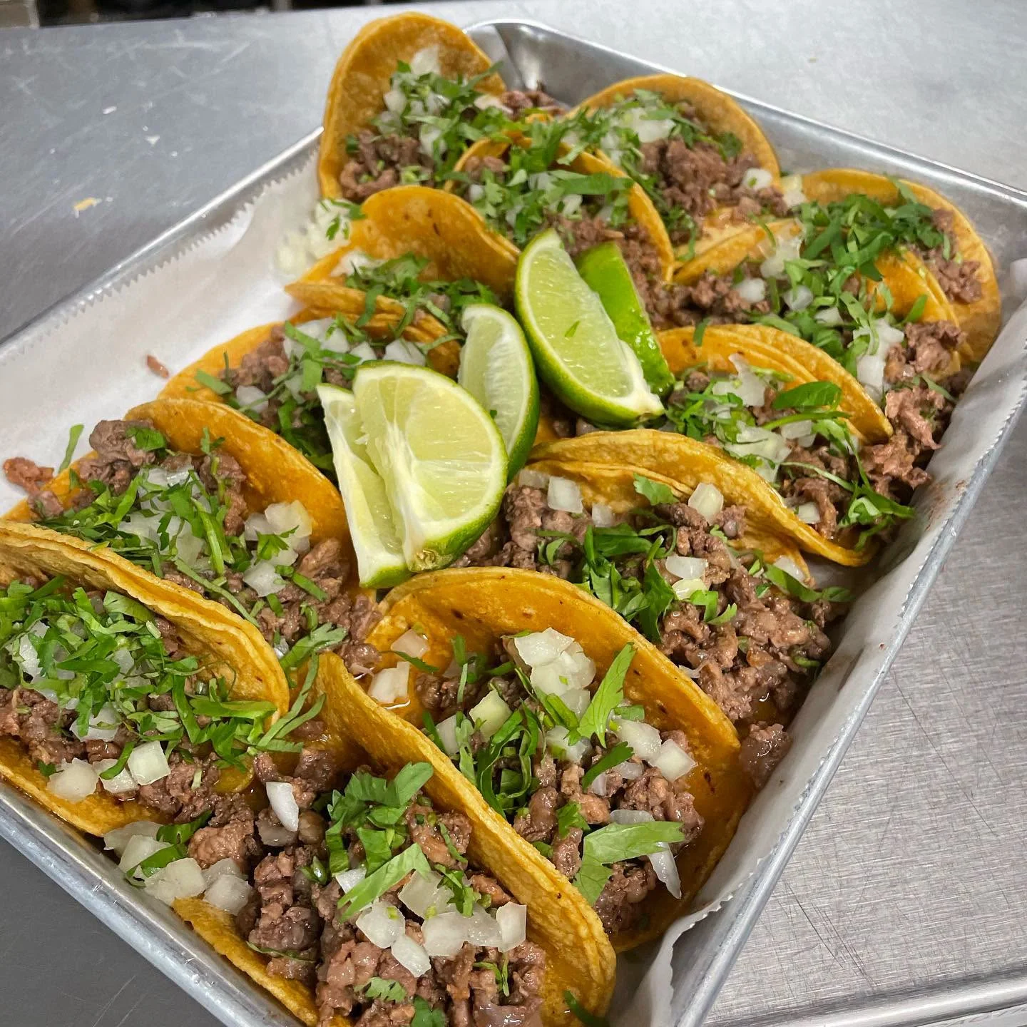 Mexican street tacos with carne asada, cilantro, onion, and lime