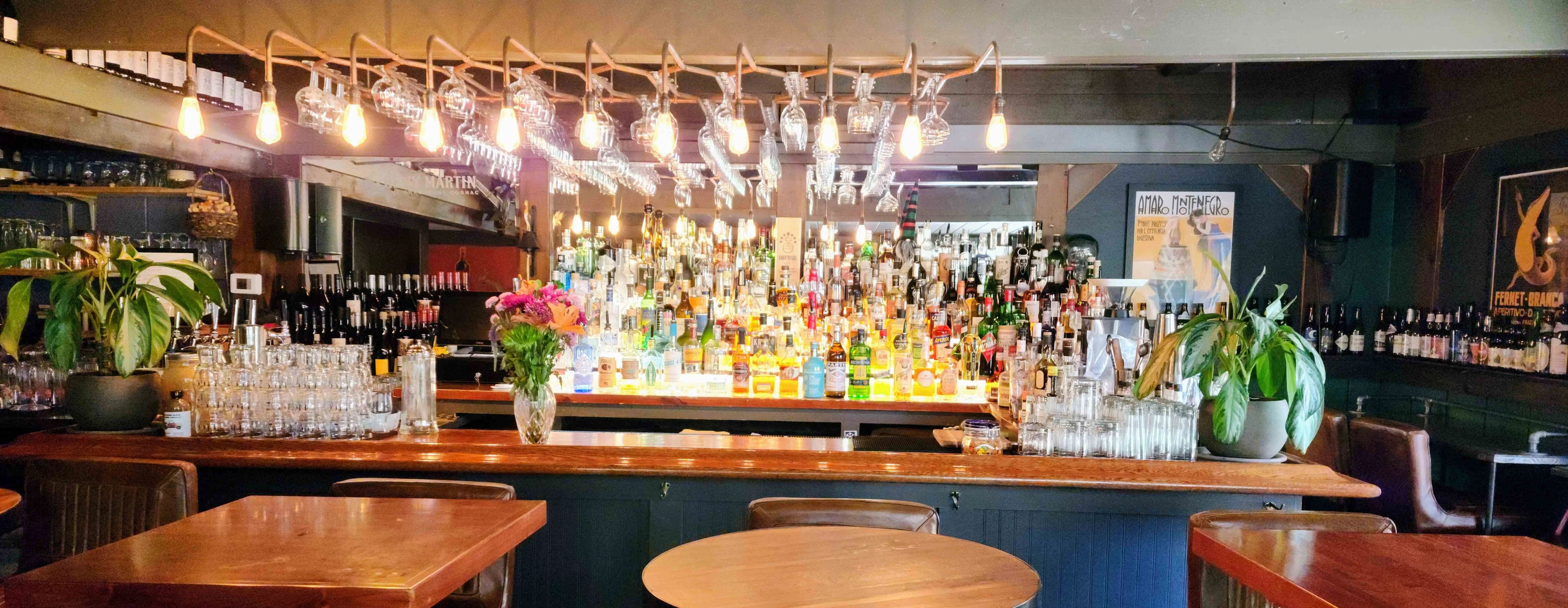 Stylish bar interior with a vibrant selection of spirits and warm lighting
