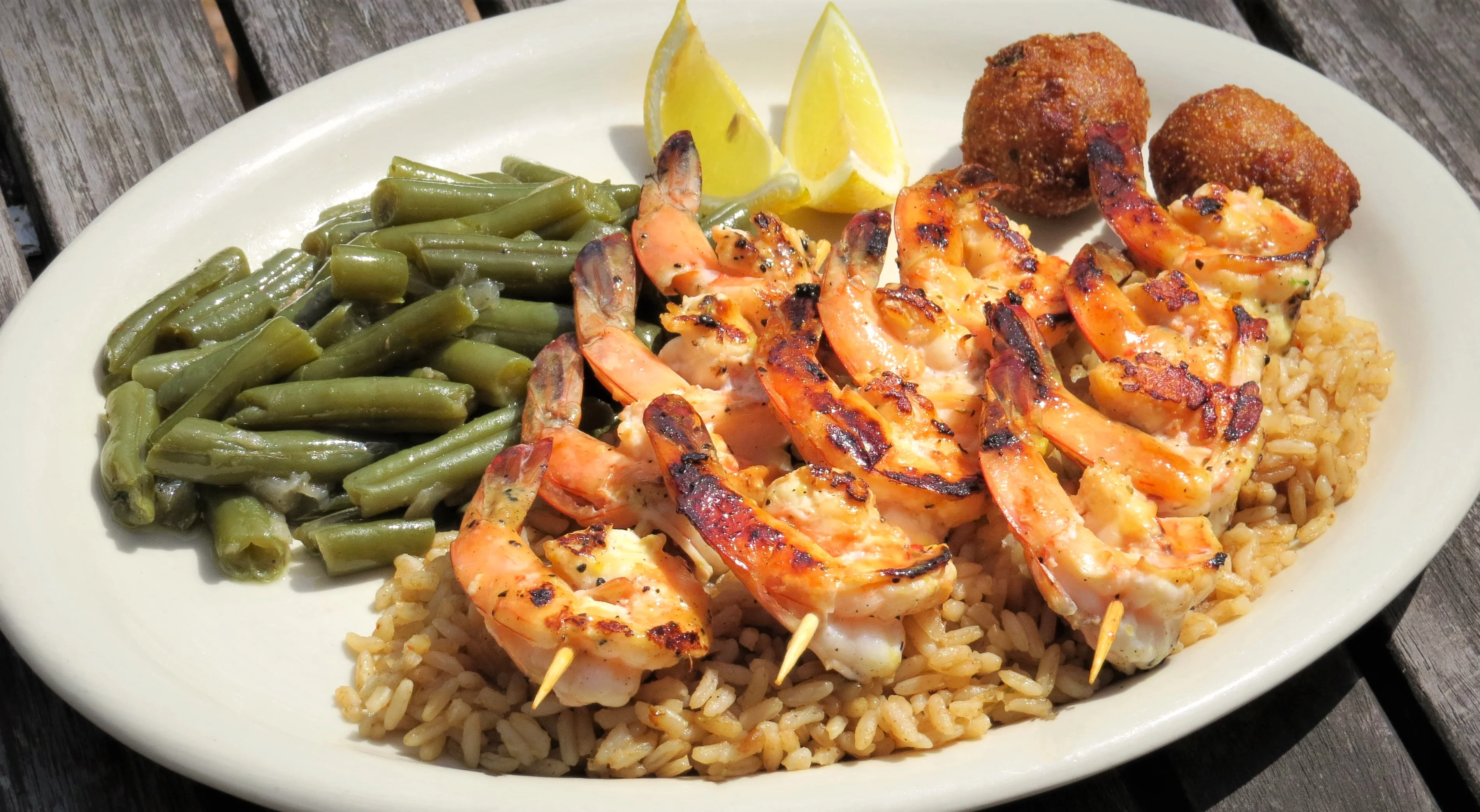 Grilled shrimp skewers with rice and green beans