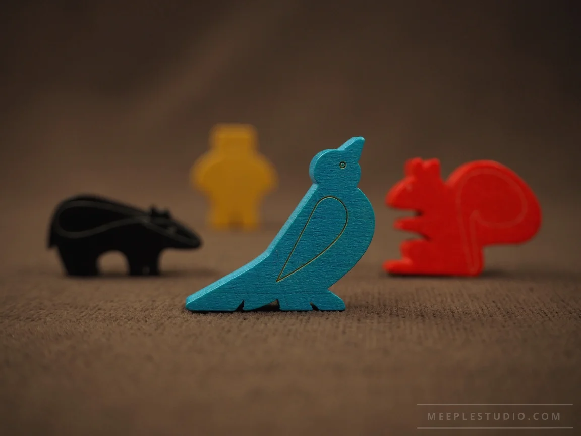Colorful wooden animal game pieces on a brown background