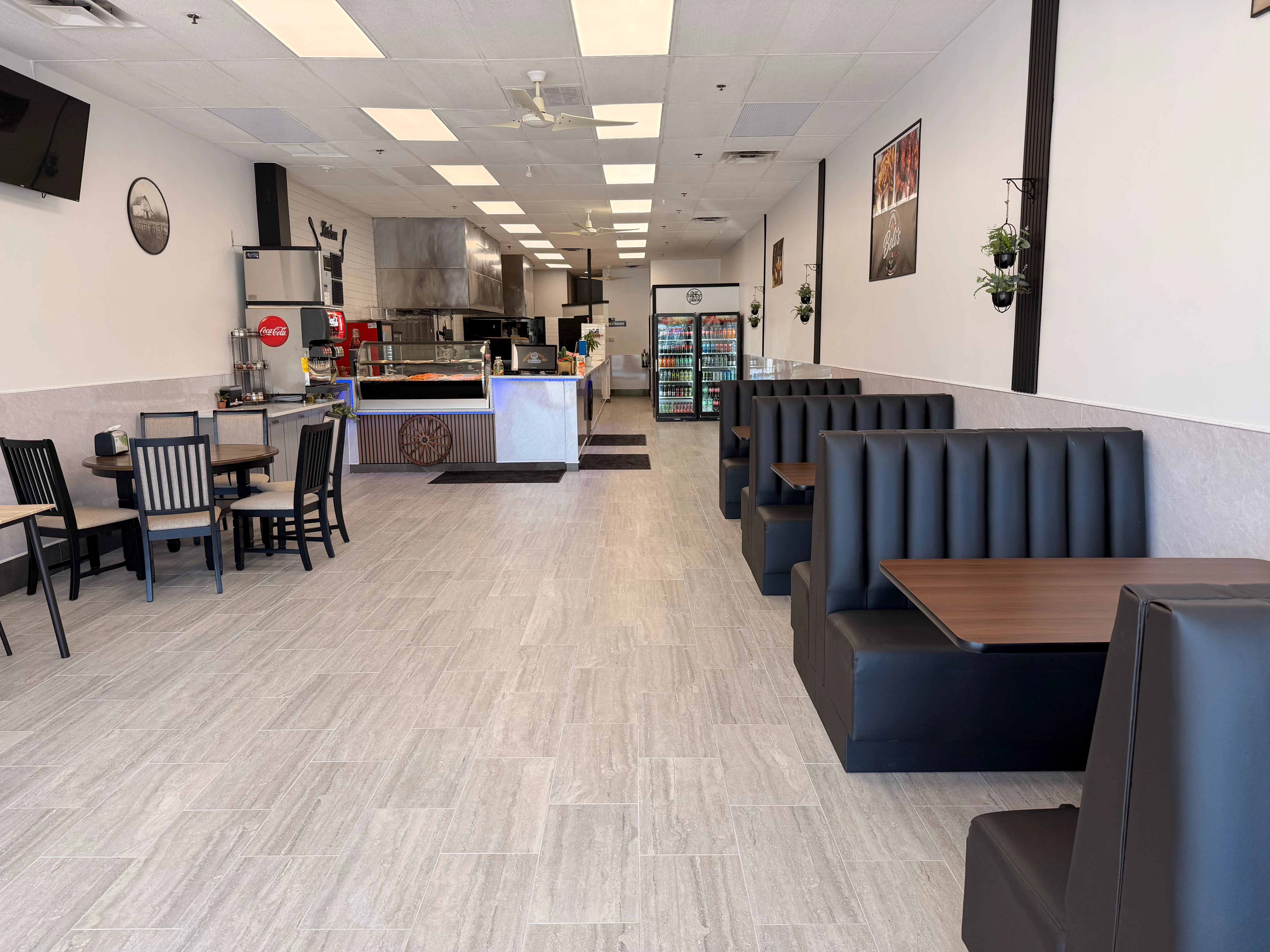 Modern restaurant interior with booths and open kitchen