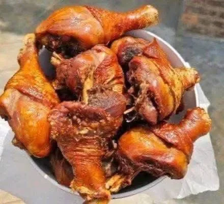 A bowl containing multiple pieces of crispy, golden-brown chicken drumsticks.