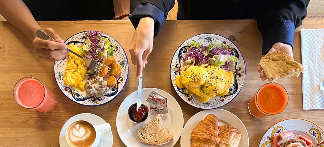 Mediterranean brunch spread with shakshuka, eggs, salads, pastries, and coffee