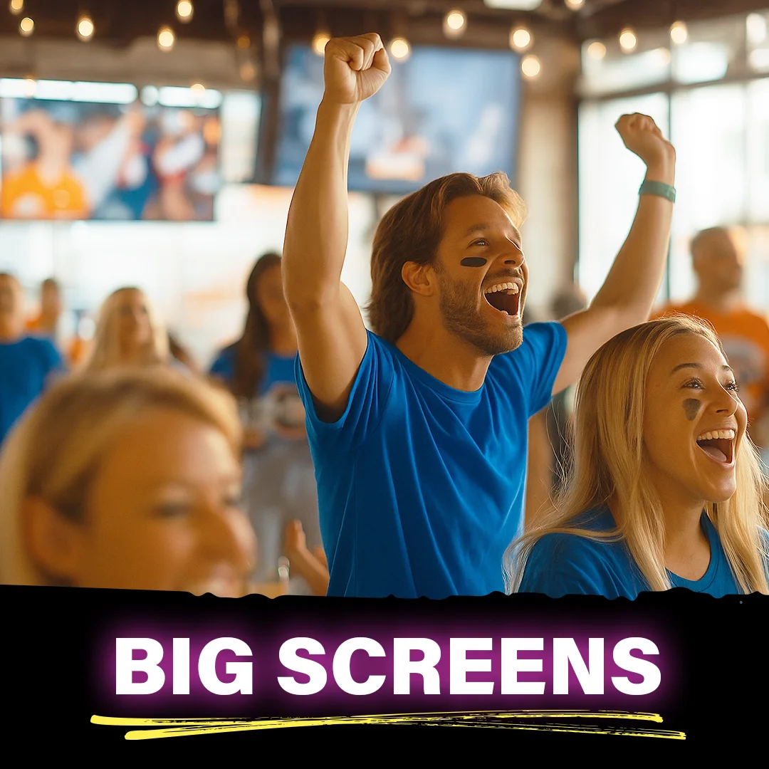 Guests cheering inside restaurant wearing blue shirts