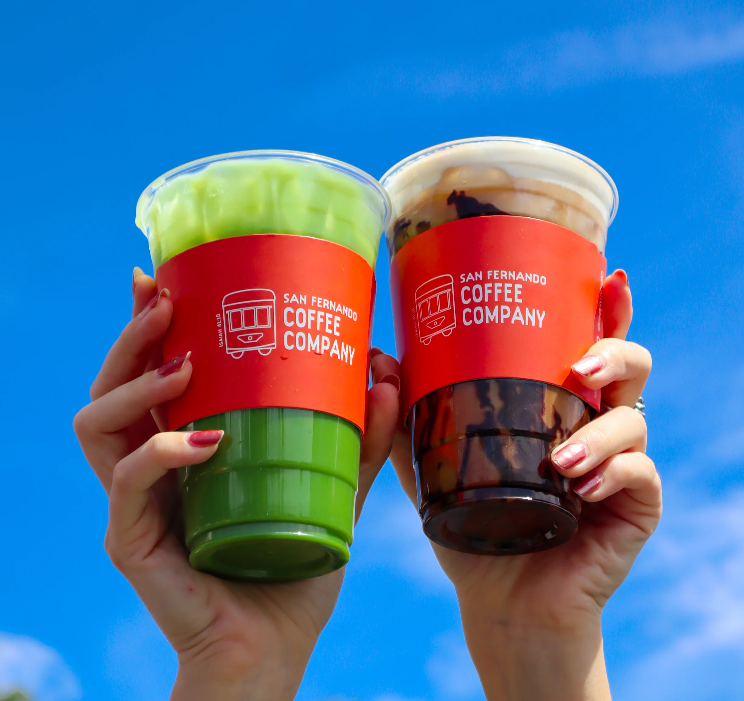 two san fernando drinks held up with sky blue background