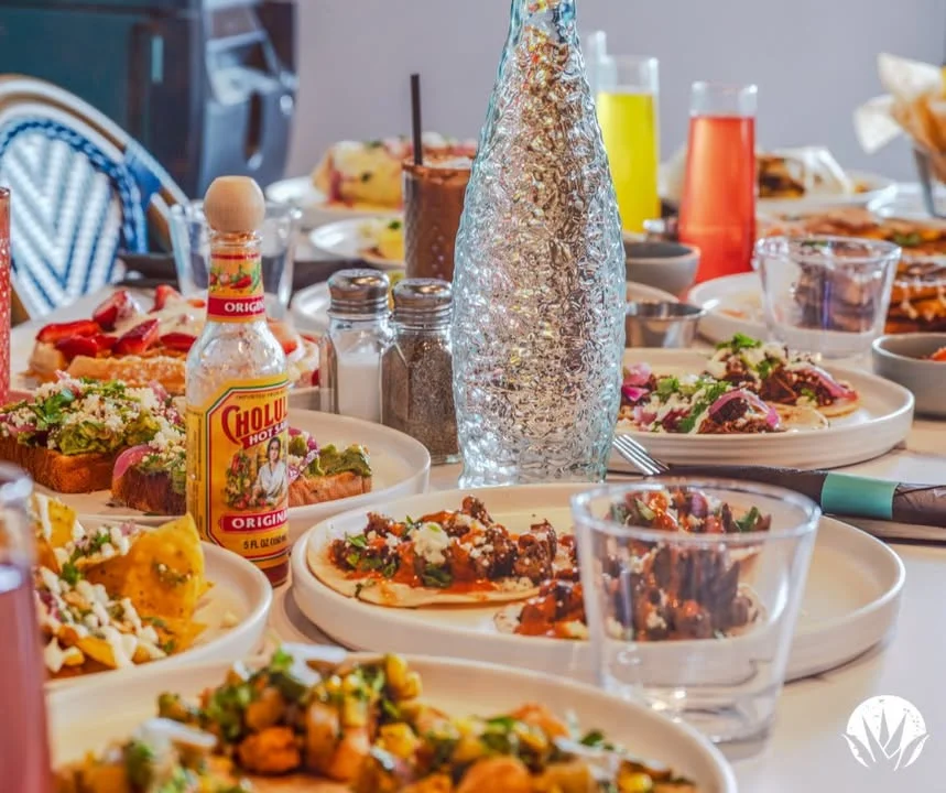 Colorful Mexican feast with tacos, nachos, and vibrant drinks on a dining table