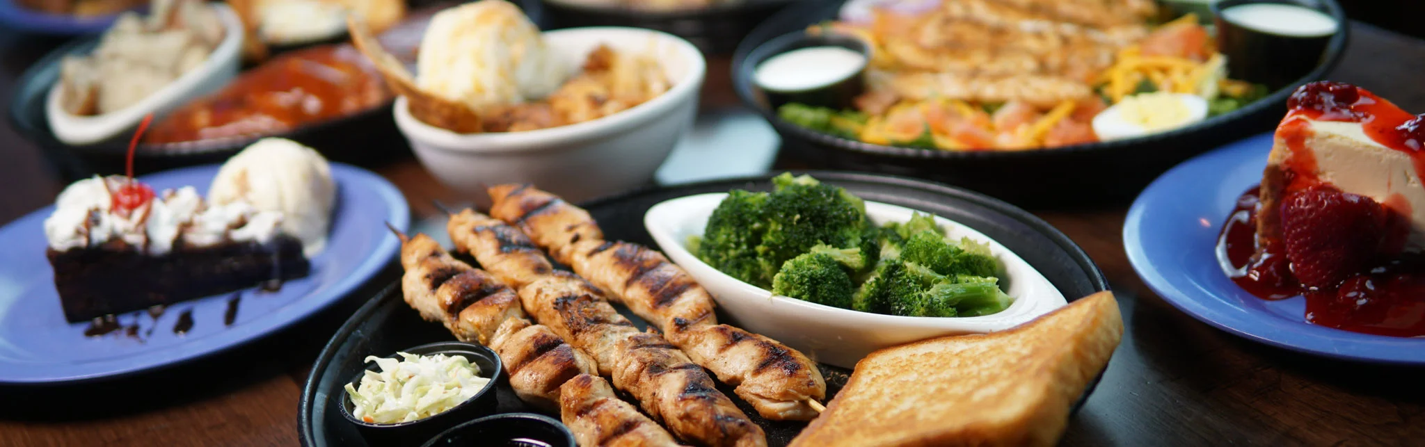 Grilled chicken skewers with sides in a casual dining setting