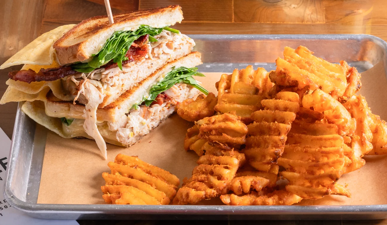Turkey melt sandwich with melted cheese on toasted bread